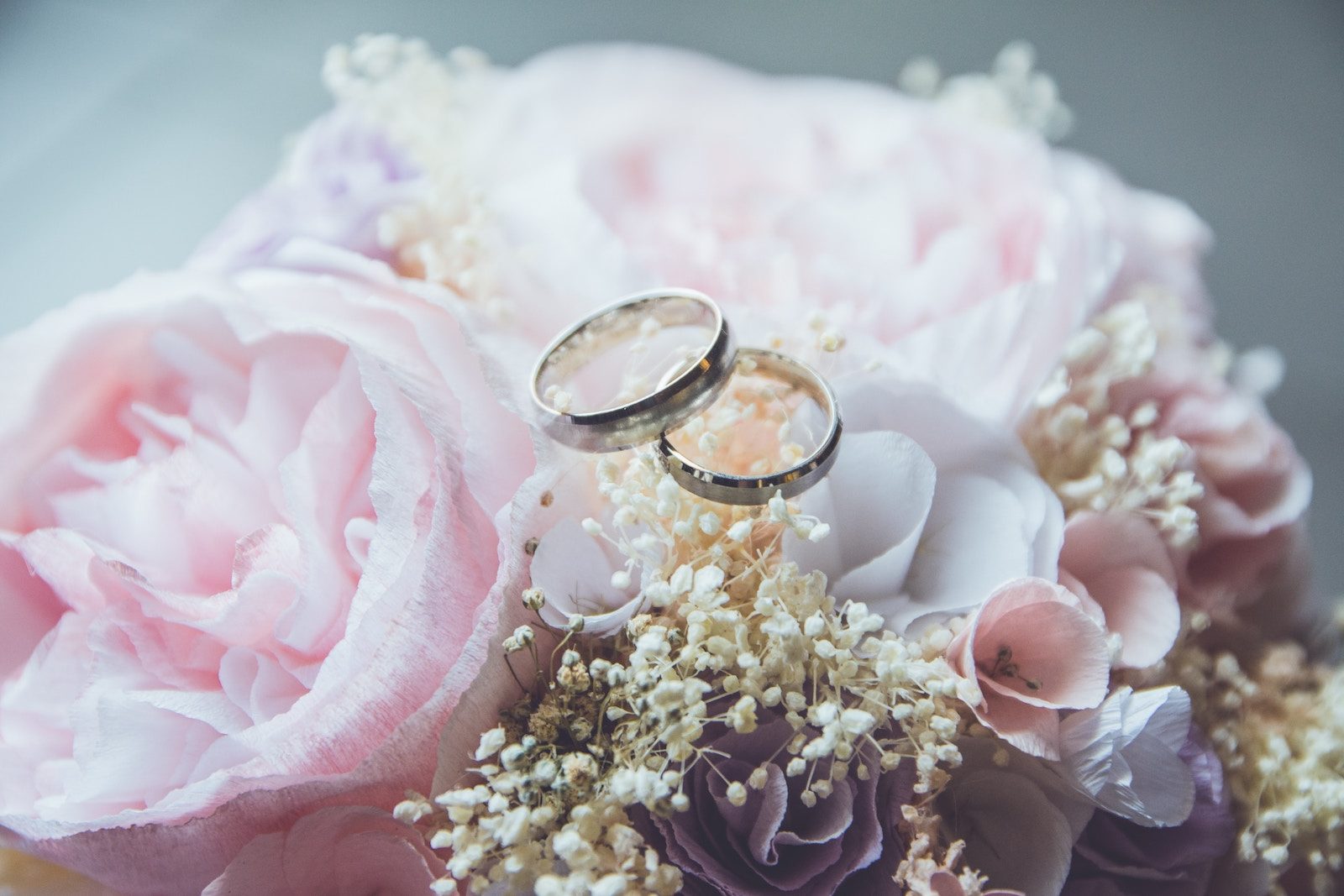 Two wedding rings paired with beautiful flowers