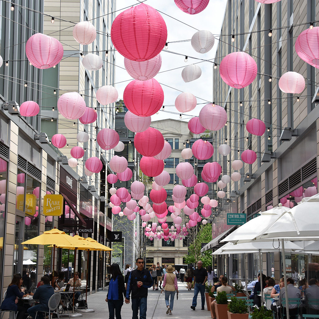 People strolling through the city center pavilion during cherry blossom season
