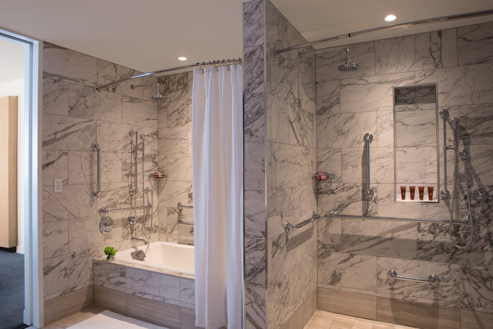 Luxury bathroom with marble walls and soft robes